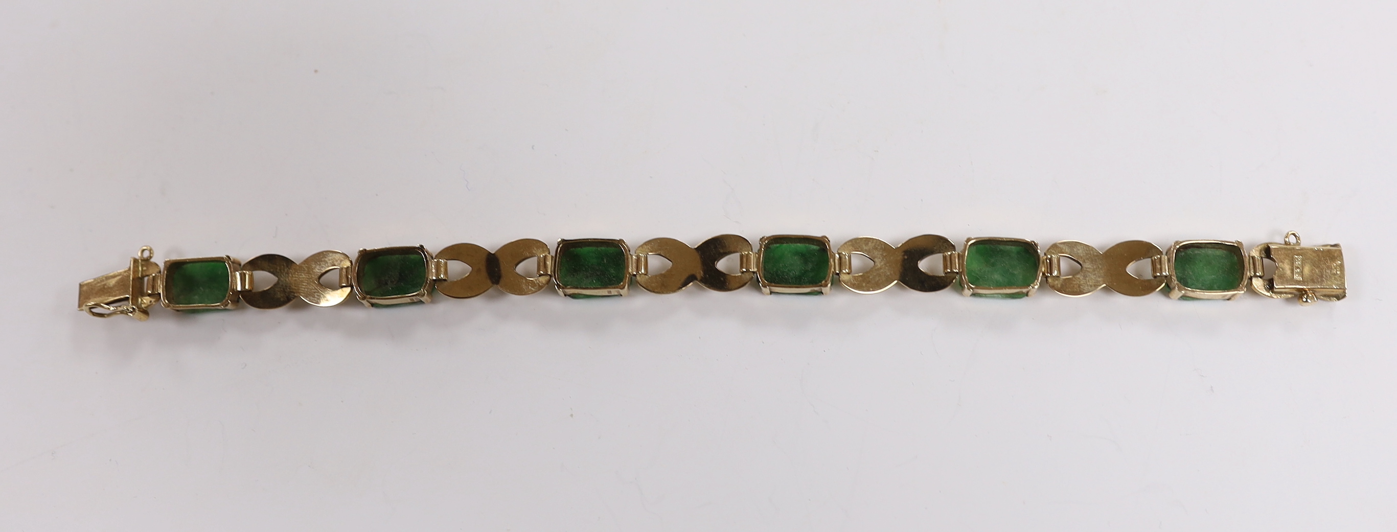 A 1960's 9ct gold and six stone carved jade panel set bracelet, by Cropp & Farr,17cm, gross weight 15.2 grams.